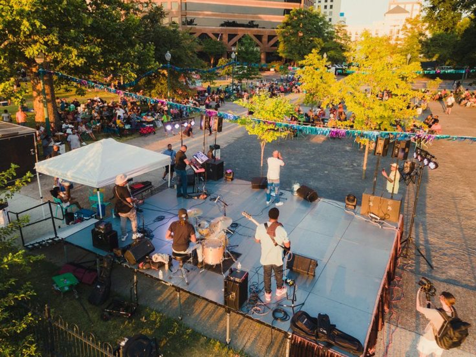 Activación con banda en vivo en espacio público, con público reunido al atardecer
